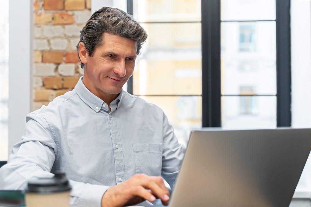 Man learning by gamification at his laptop Man learning by gamification at his laptop
