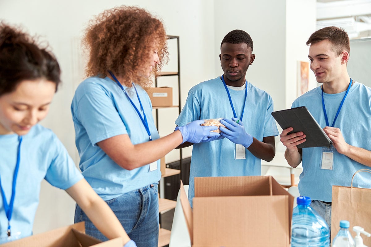 Volunteers packing goods into boxes Volunteers packing goods into boxes